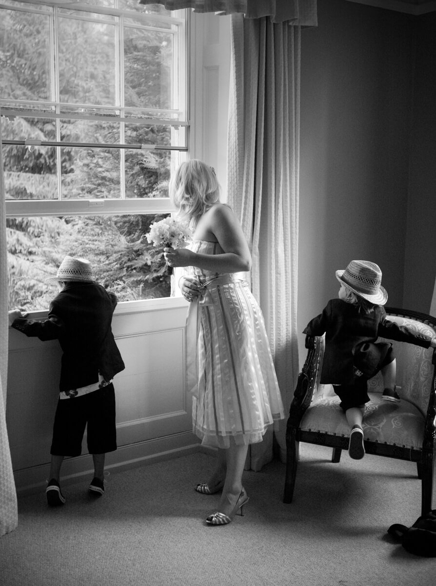 Bridesmaid and pageboys looking out of window at Lemore Manor weddings