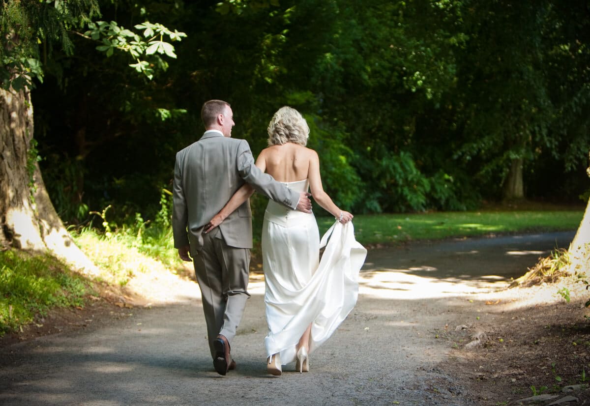 Bride and groom walking down country lane at Lemore Manor weddings