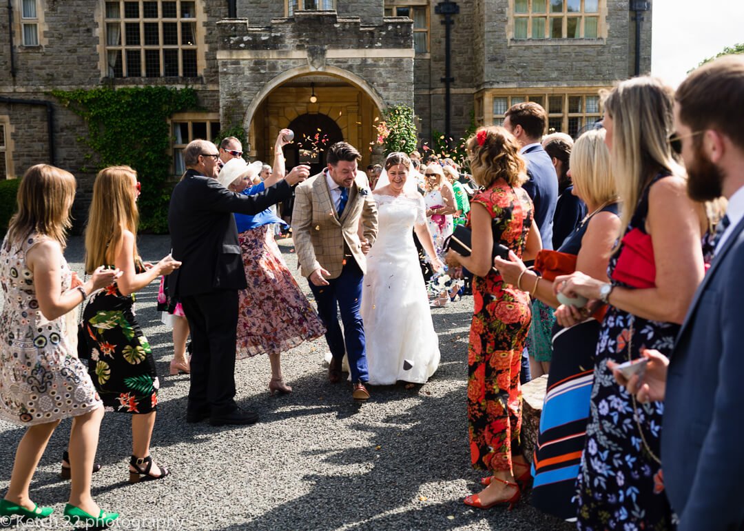 Wedding guests shower bride and groom with confetti at Herefordshire wedding