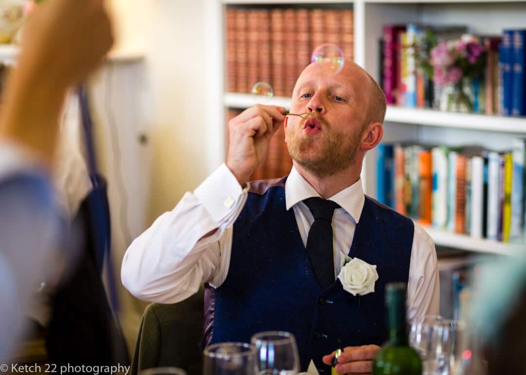 Wedding guest blowing bubbles at Country House