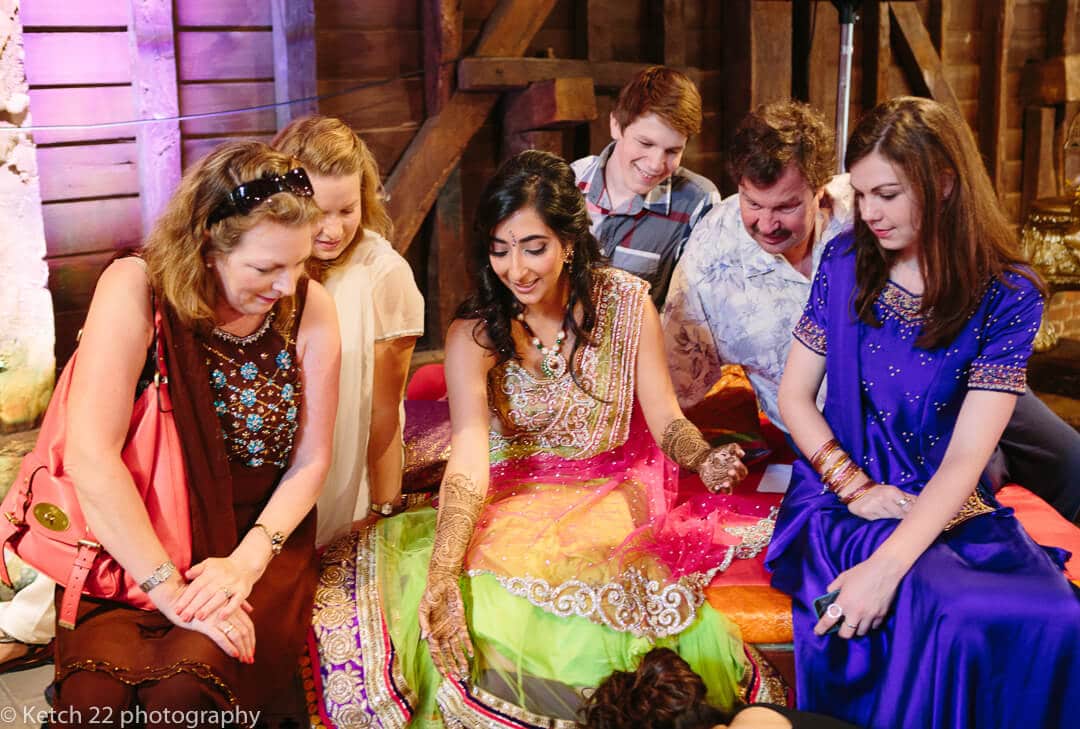 Wedding guests chatting to hindu bride 
