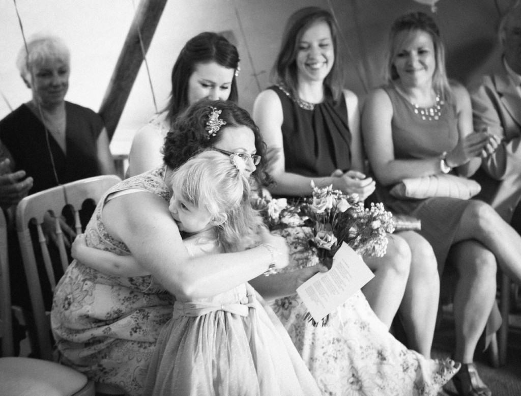 Bridesmaids hugging at wedding ceremony in Shropshire