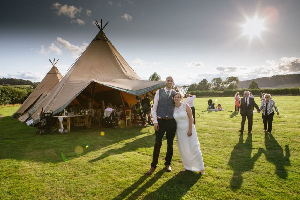 Portrait of bride and groom in evening sun light outside marquee at wedding in Shropshire