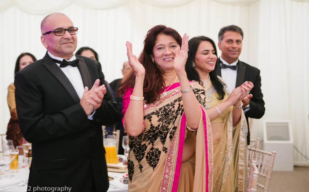 Hindu wedding guests clapping