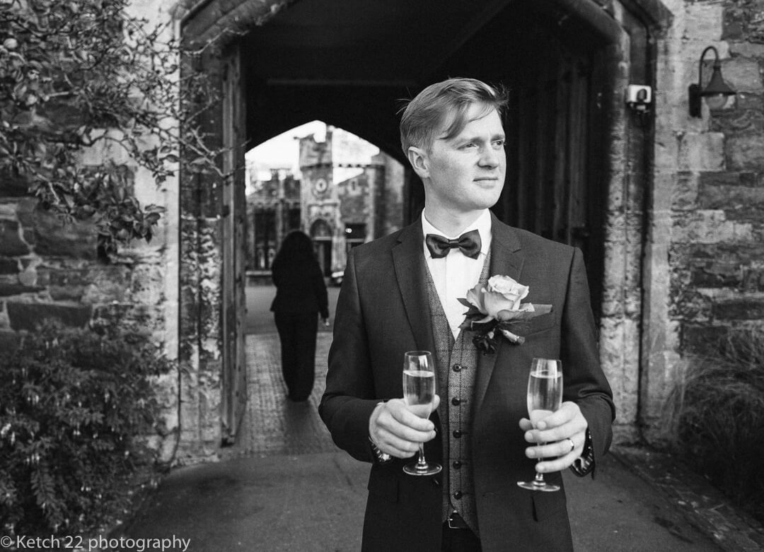 Groom takes a quiet moment with drink at Winter Wedding