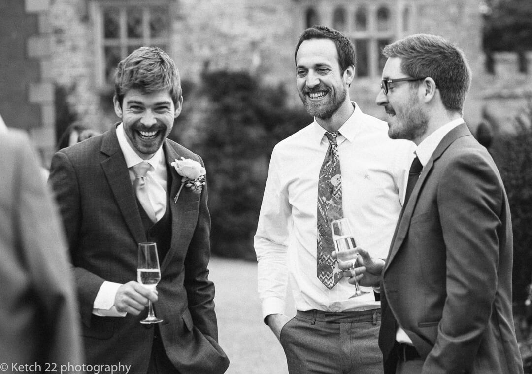 Groom and his friends relax, laugh and enjoy a drink