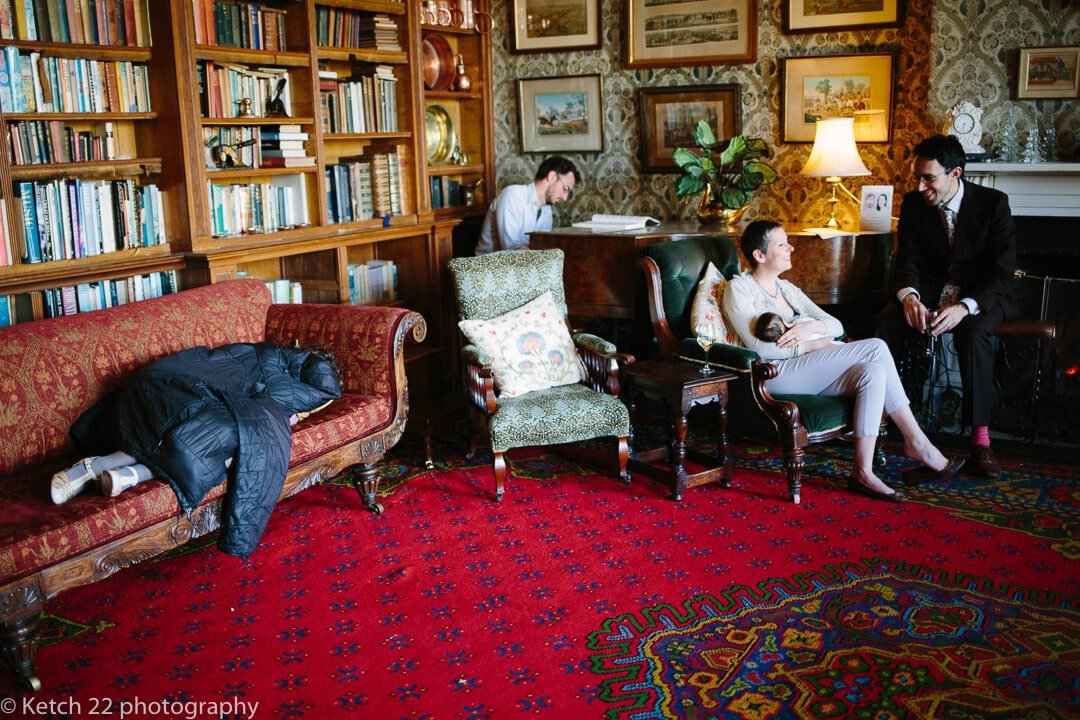 Story telling wedding photo of guests relaxing in lounge