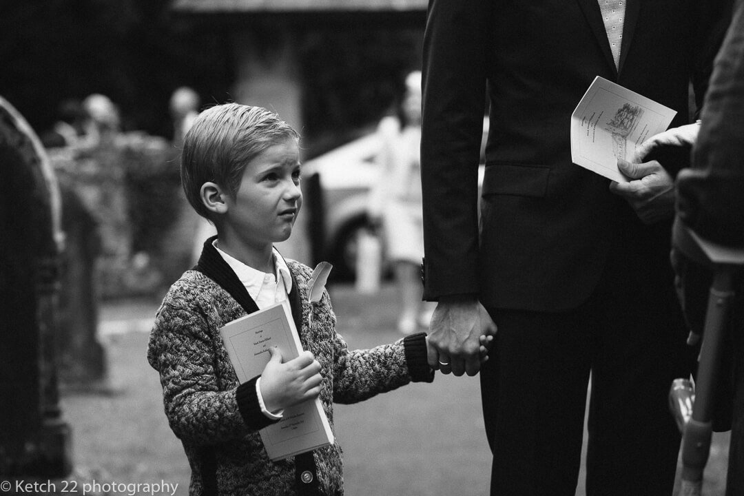 little boy holding Dad's hand at wedding