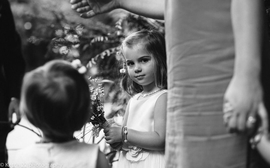 Flower girl looking into the camera before wedding ceremony