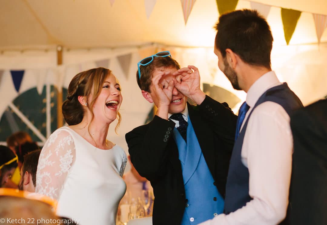 Bride and groom having fun with wedding guest