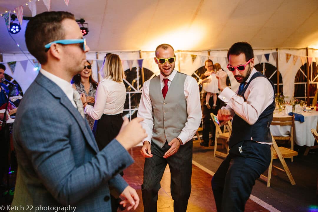 Wedding guests with retro sunglasses dancing