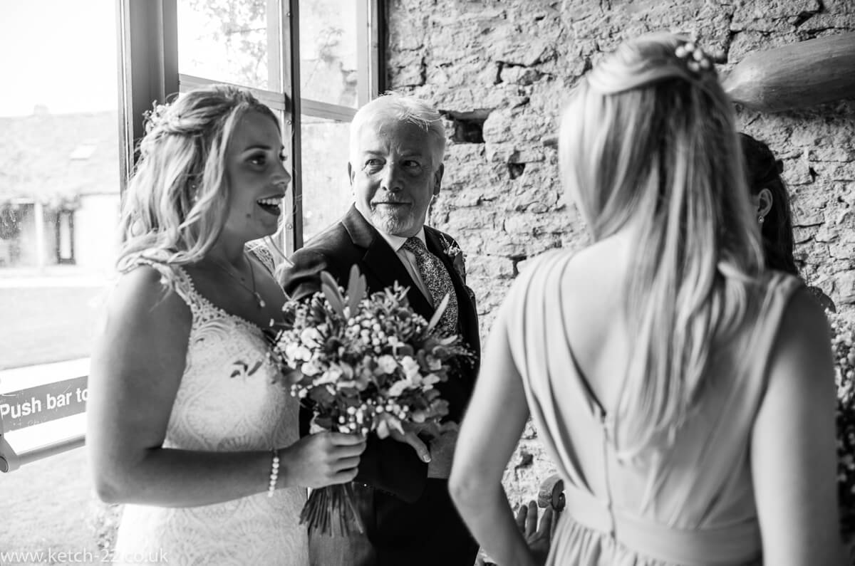 Father of bride looks at his daughter before wedding ceremony