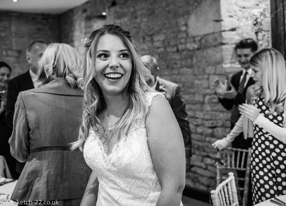 Happy bride enters dinning room at Weddings at The great Tythe Barn
