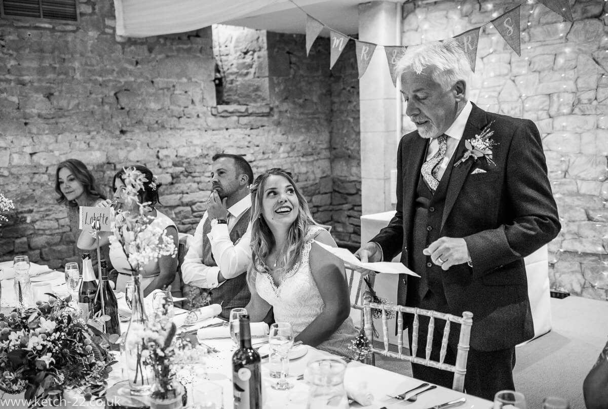 Father of bride making speech as daughter looks on