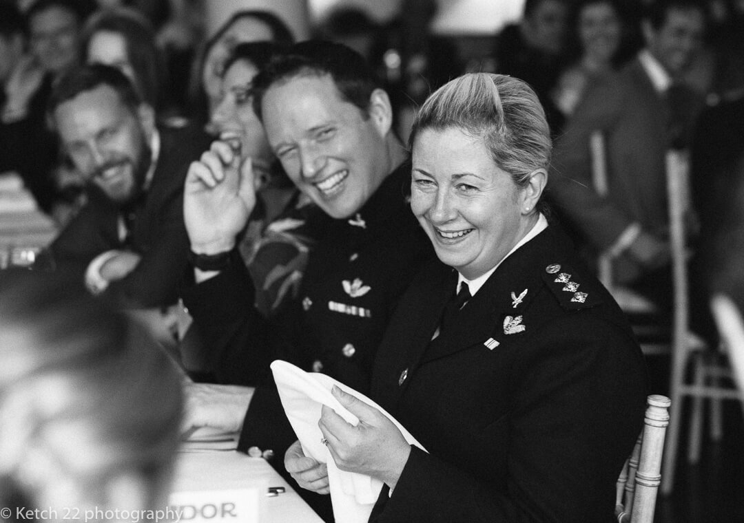 Wedding guests in army uniform laughing 