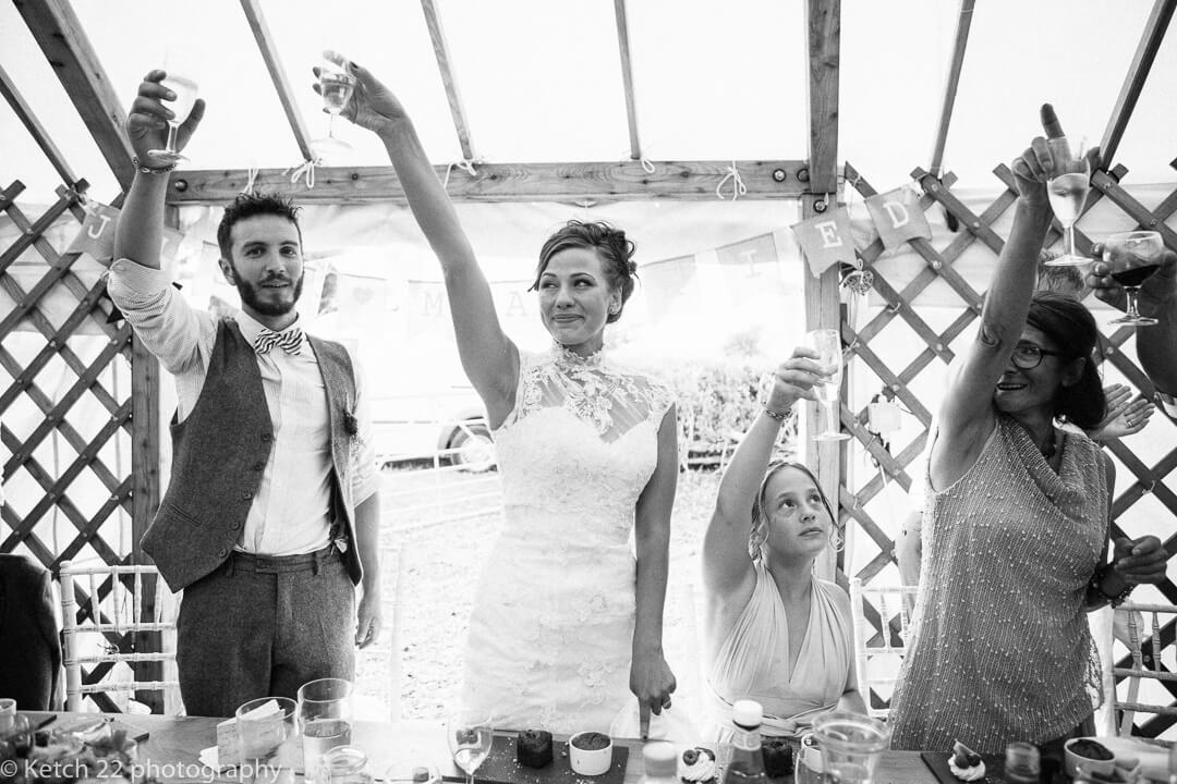 Bride and groom toasting at wedding speeches