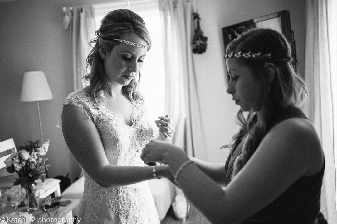 Bride putting bracelet at wedding preparations