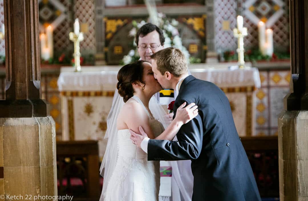 Bride and groom kissing at wedding ceremony