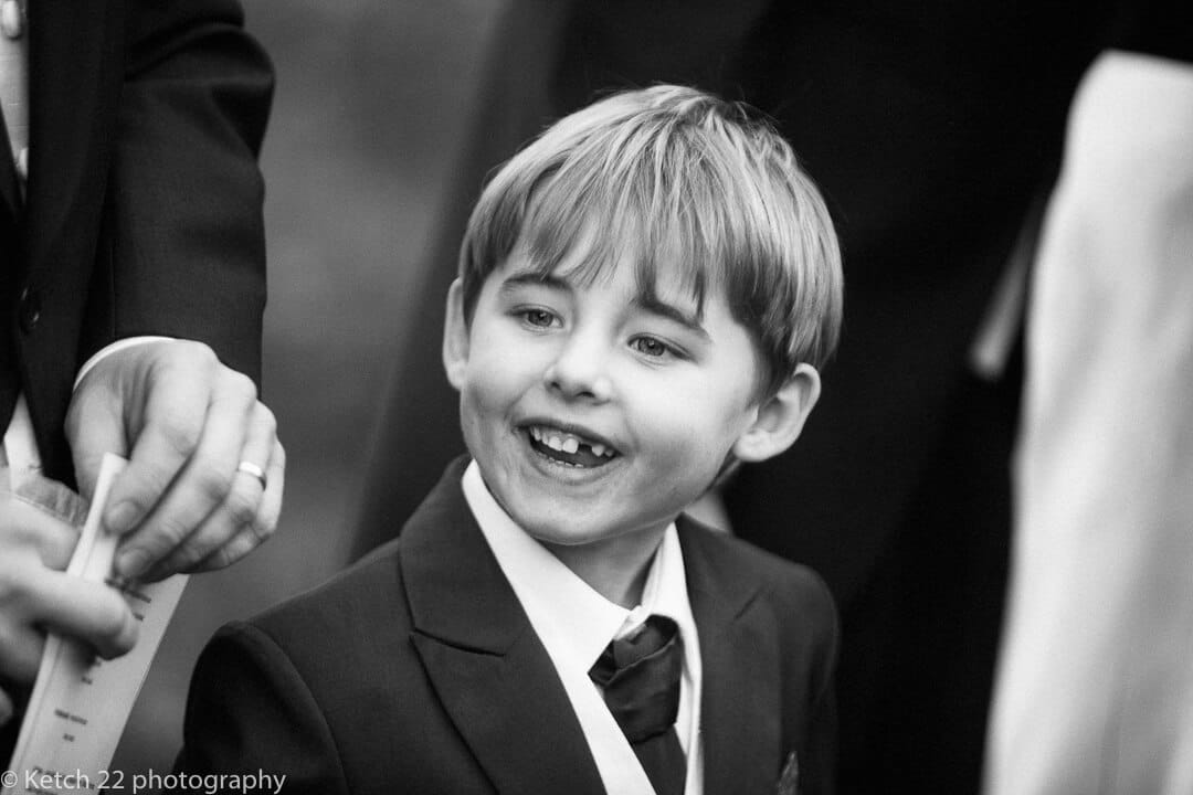 Page boy smiling at reportage wedding