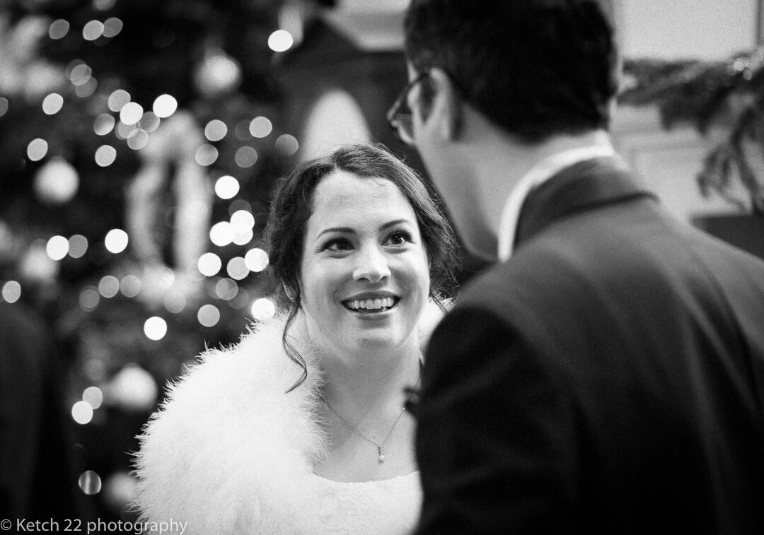 Bride chatting to best man at Christmas wedding