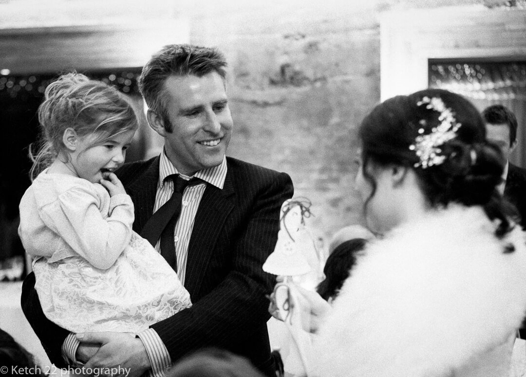Father and daughter talking to bride at wedding reception