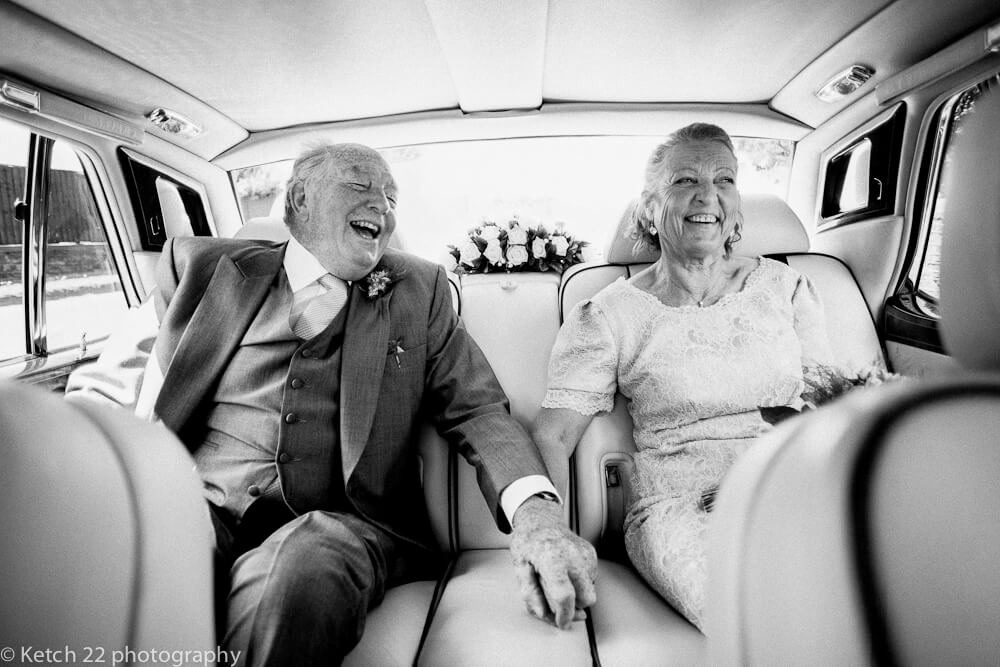 Never too late for love with older newly weddings laughing in car Gloucestershire