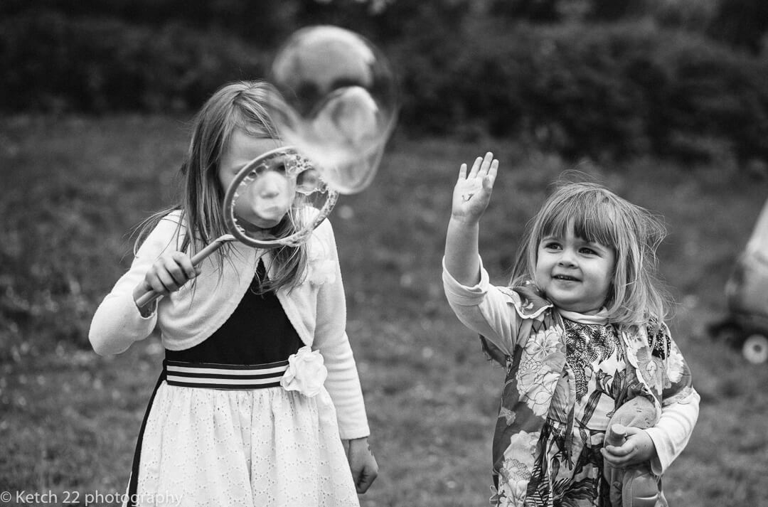 Kids playing with bubbles at Gloucestershire wedding