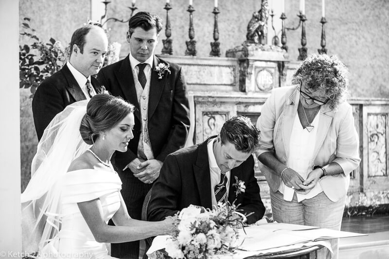 Signing the registrar at Dorset wedding