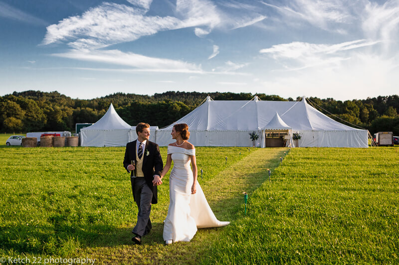Bride and groom in front of Marquee at Dorset summer wedding