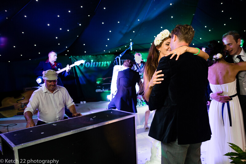 Bride and groom kissing at wedding reception in Dorset