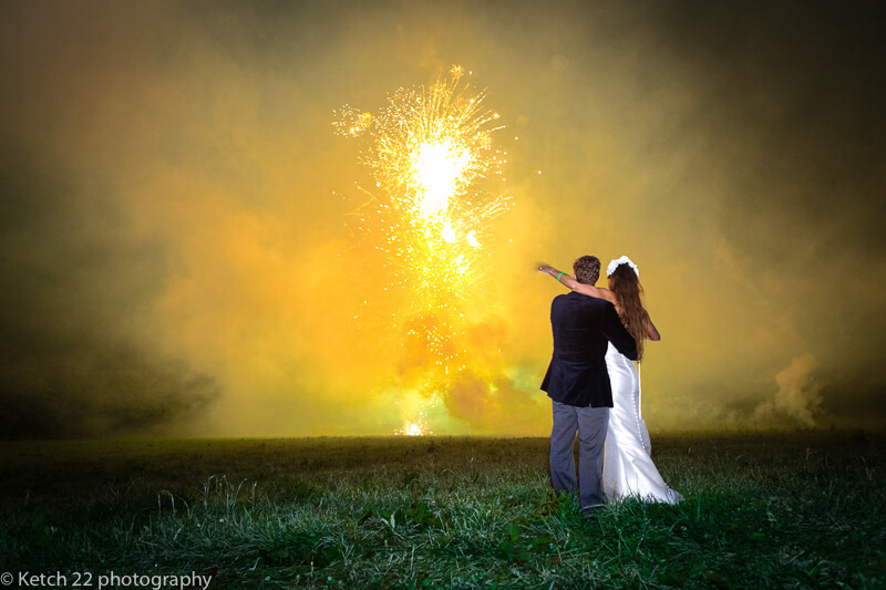 Bride and groom watching fireworks at Dorset summer wedding