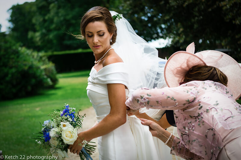 Mum getting bride ready before wedding ceremony in Dorset