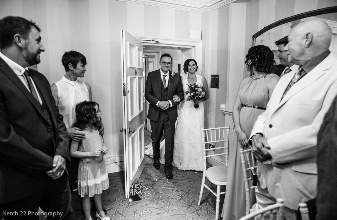 Bride and bother enter wedding ceremony