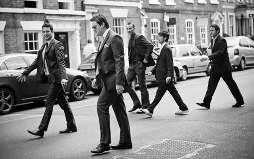 Gloucestershire Wedding Photographer image of Groom and groomsmen walking across a road
