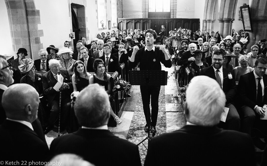 Conductor and choir singing at Church wedding