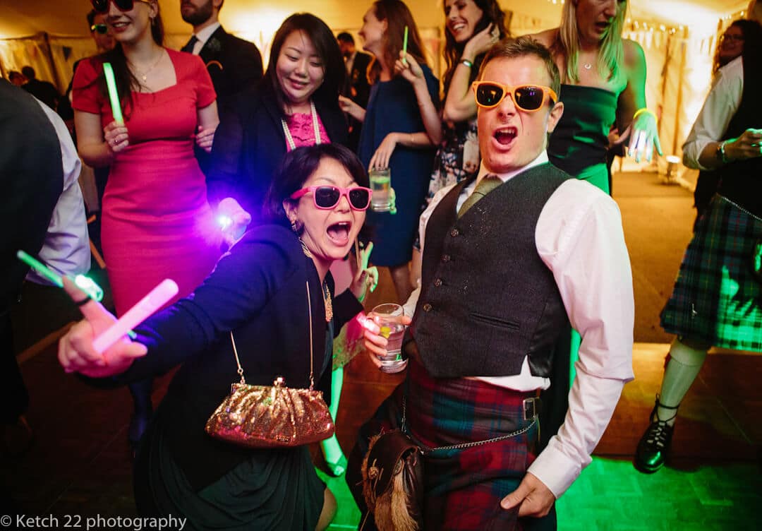 Wedding guests with sunglasses dancing