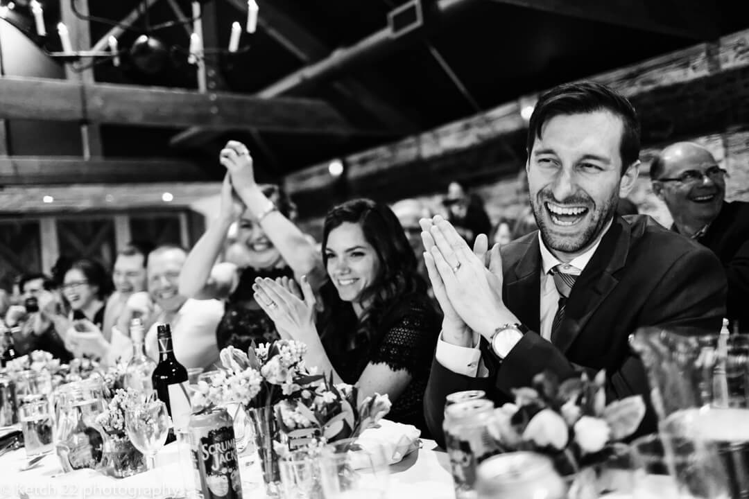 Storytelling wedding image of guests laughing at the speeches