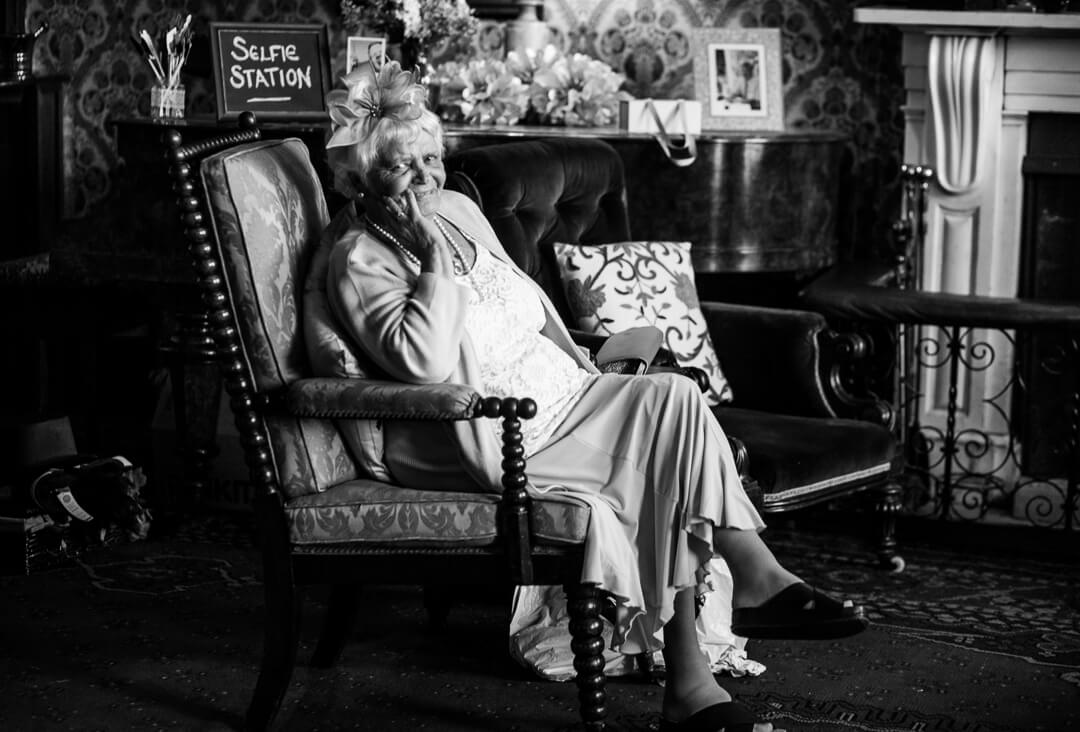 Granny relaxing in chair at Homme House wedding