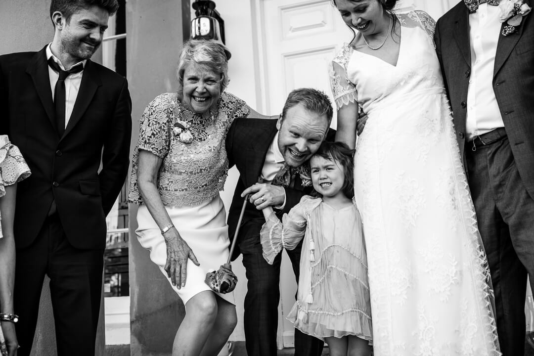 Fun moment with groom and little girl at country house wedding
