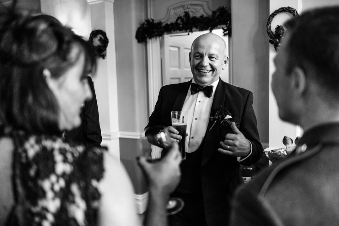 Father of the groom chatting with wedding guests