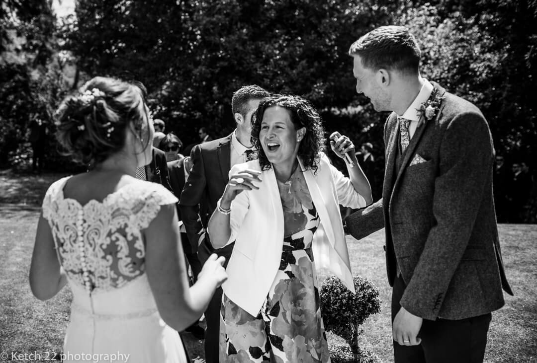 Wedding guests greeting bride
