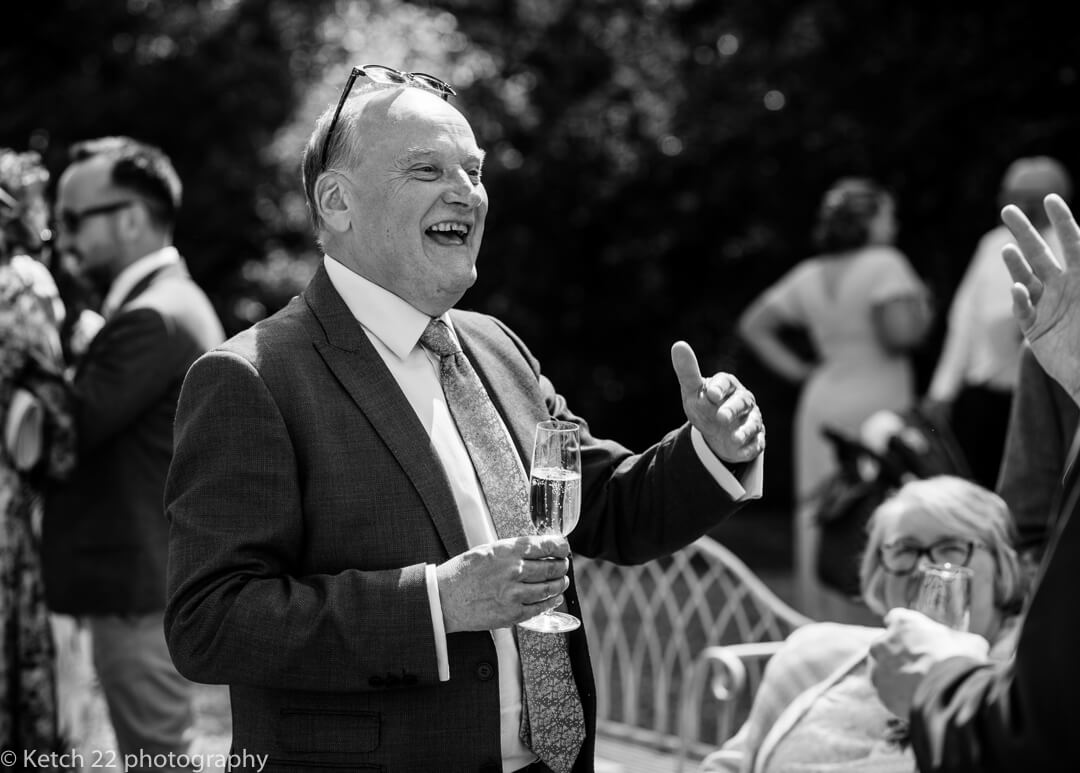 Wedding guest on lawn with champagne