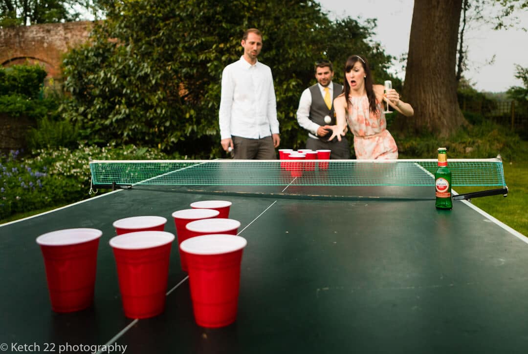 Playing ping pong in the garden at wedding