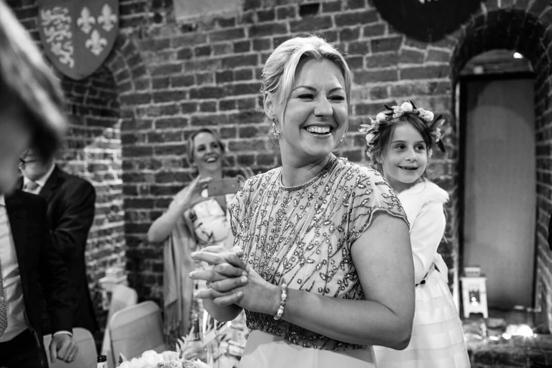 Bridesmaid laughing at wedding reception