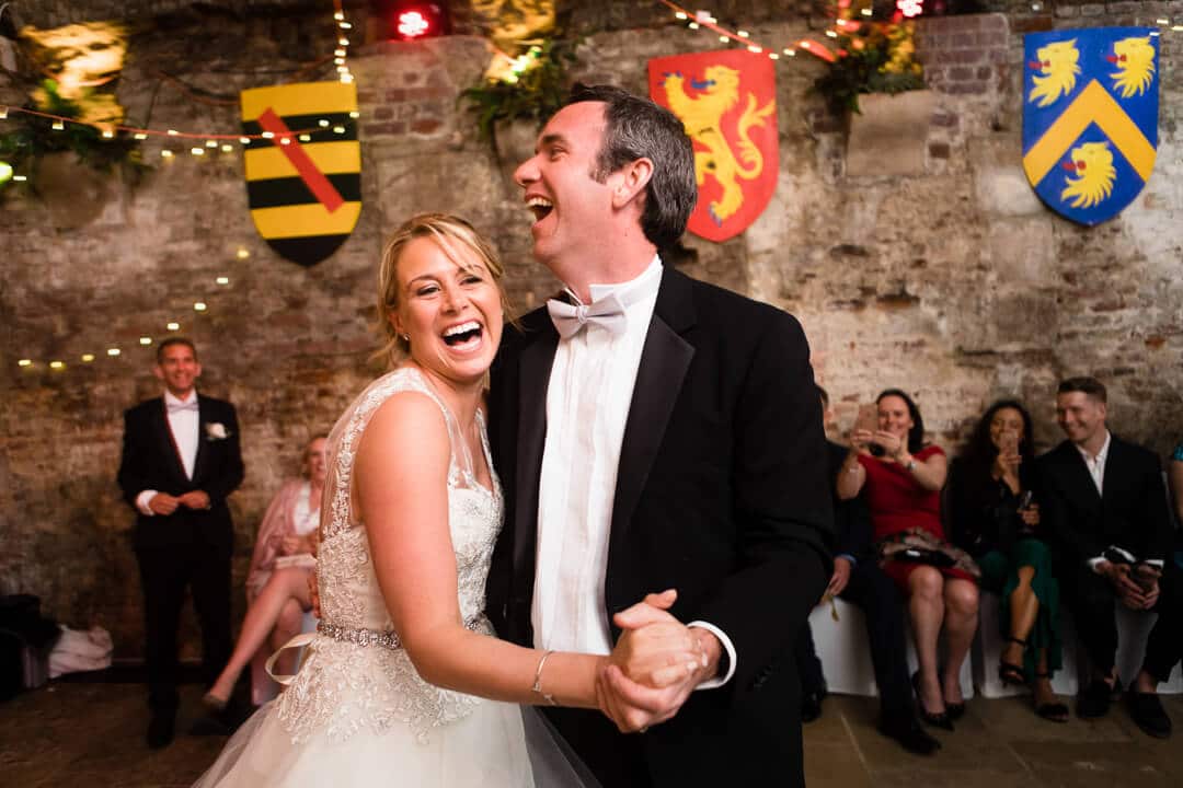 Reportage weding photo of bride and groom laughing at first dance