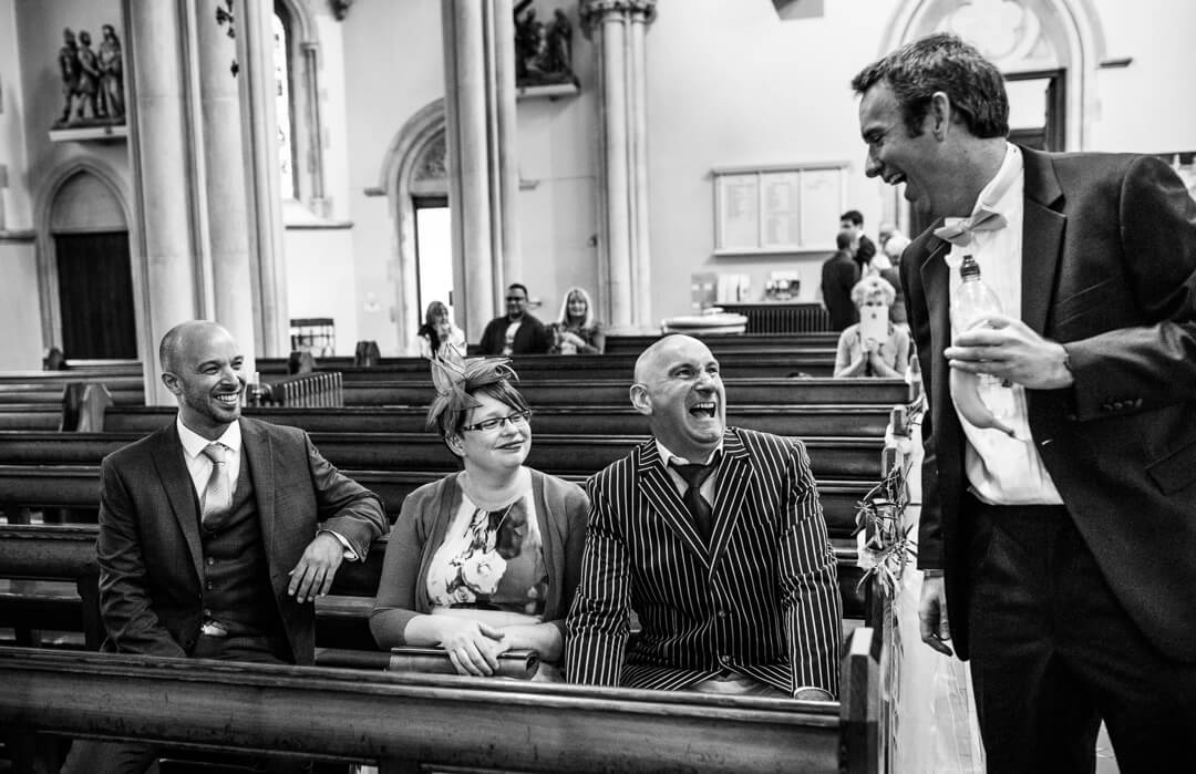 Groom greeting wedding guests in Church