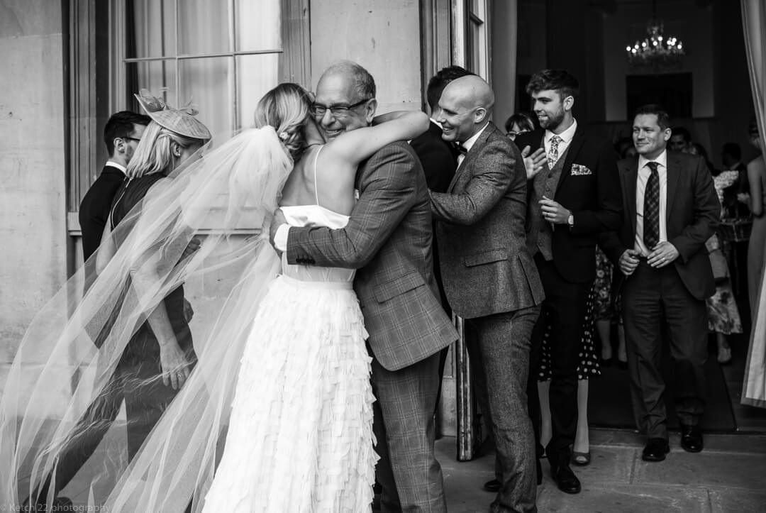Dad hugging bride at Cheltenham wedding ceremony Gloucestershire