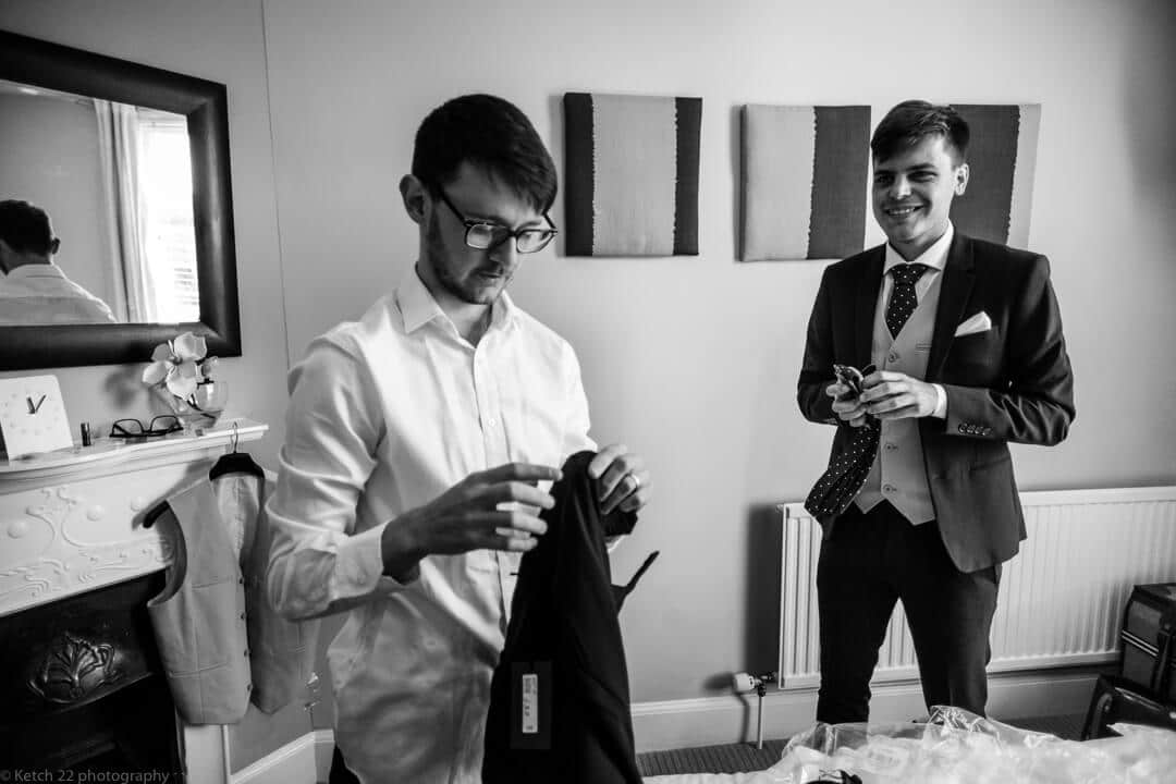 Best man and groom getting ready