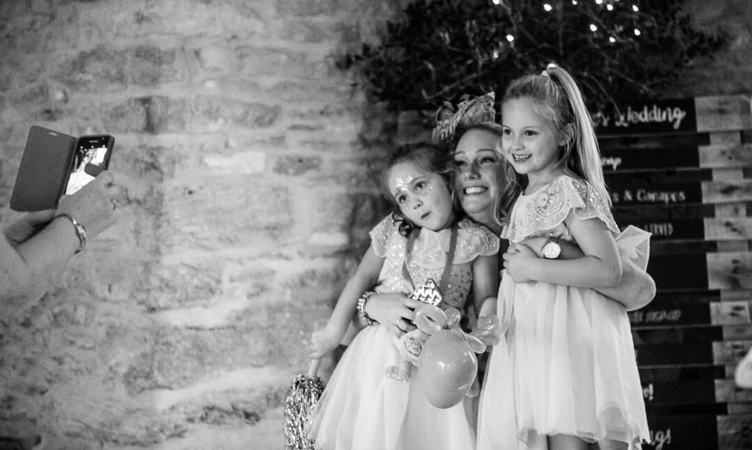 Flower girls posing for camera at Cotswold wedding