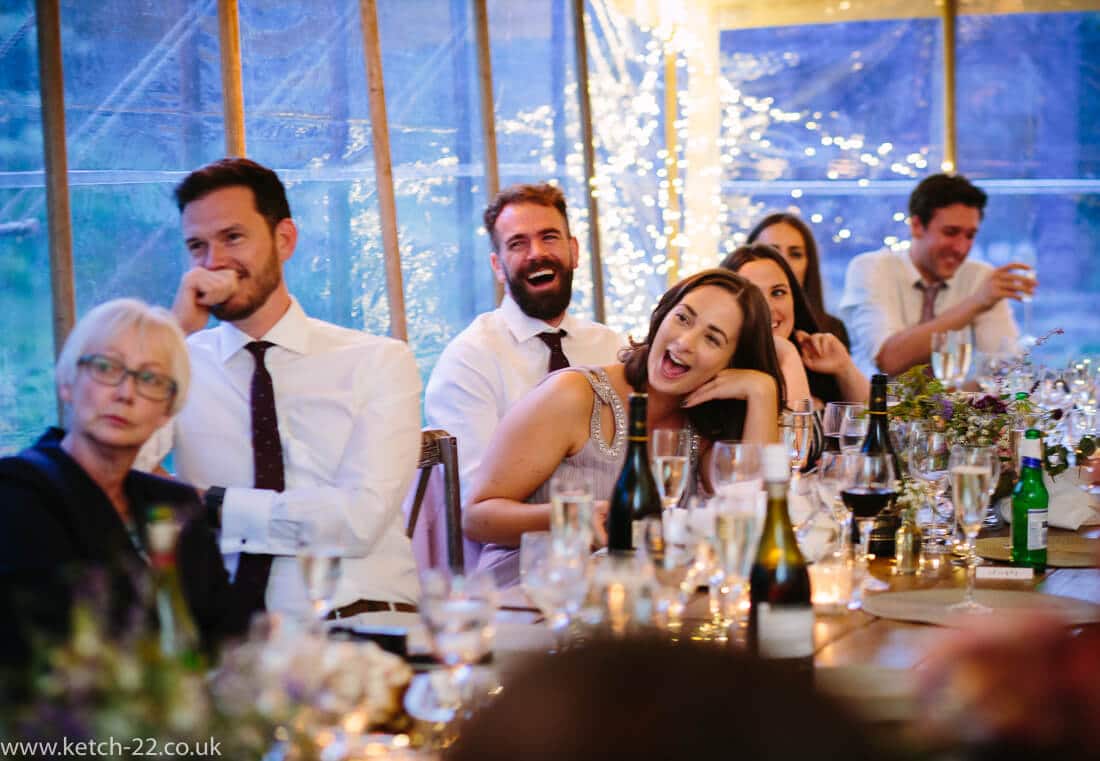 Guests in wedding marquee listening to speeches